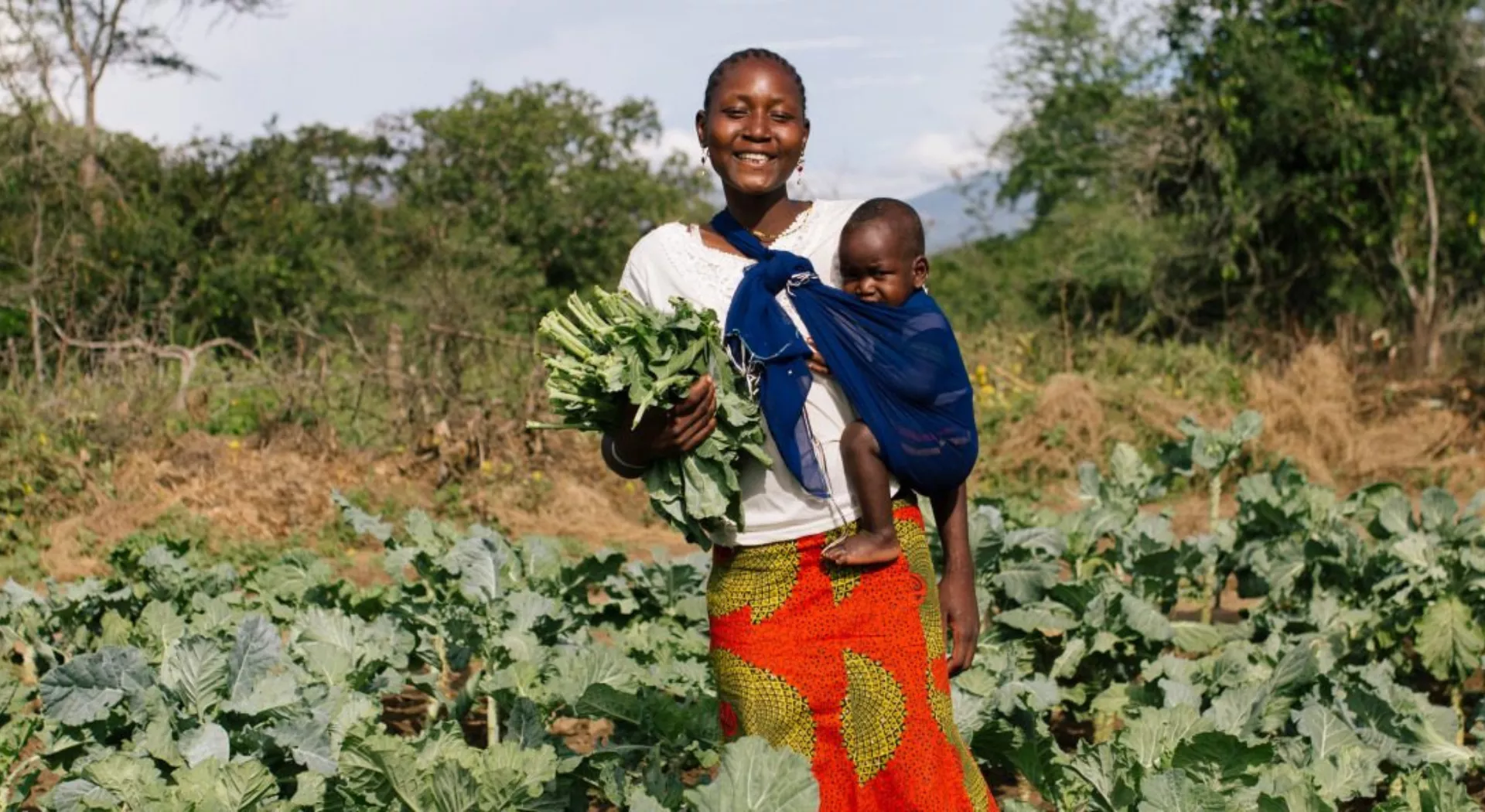 Ernährungssicherheit: Mutter mit Baby bestellt ihr Feld in Burundi
