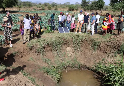 Besuch in Uganda: Landwirte zeigen den Unternehmern eine solarbetriebenen Wasserpumpe
